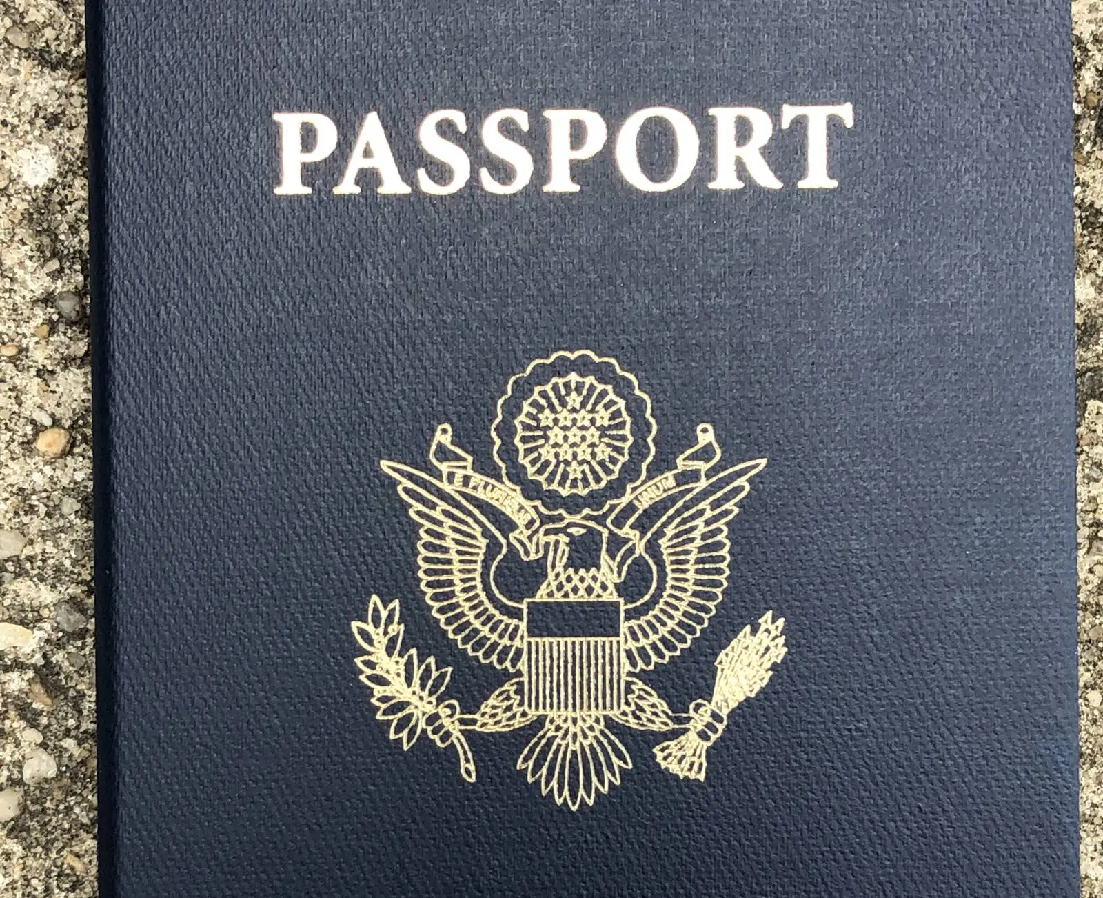 The front cover of a United States passport book with the gold eagle seal