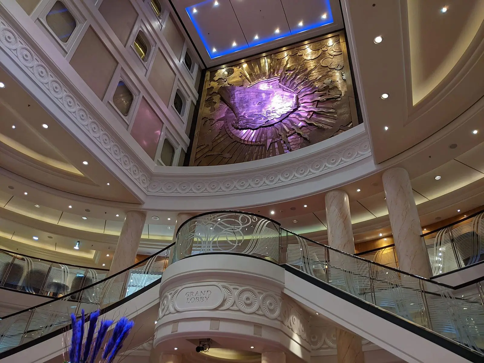 The Grand Lobby of Queen Mary 2 seen from Deck 2, with its curved staircase and balconies