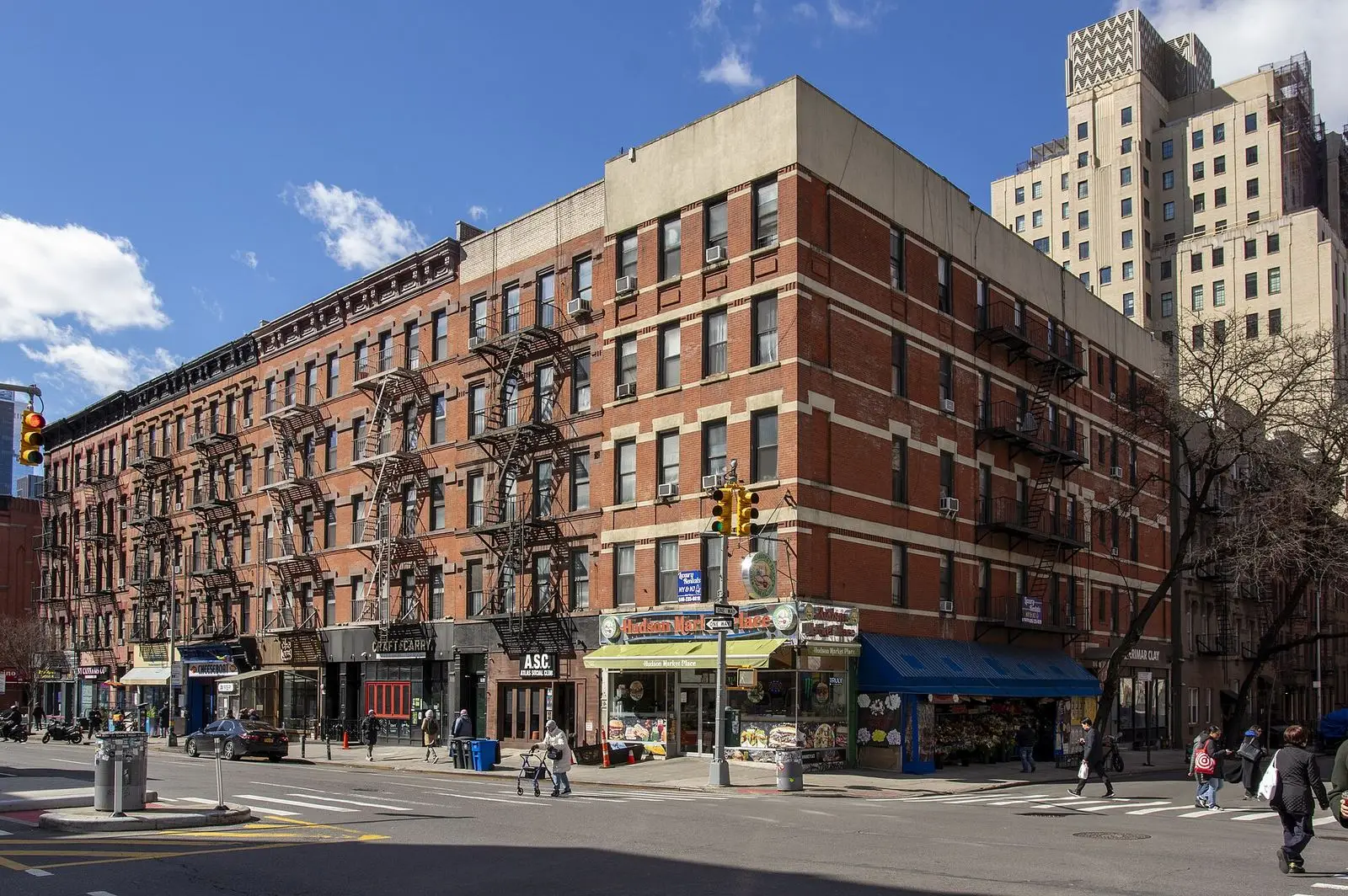 West 51st Street and 9th Avenue in Hell's Kitchen, Manhattan, with brick apartment buildings and shops
