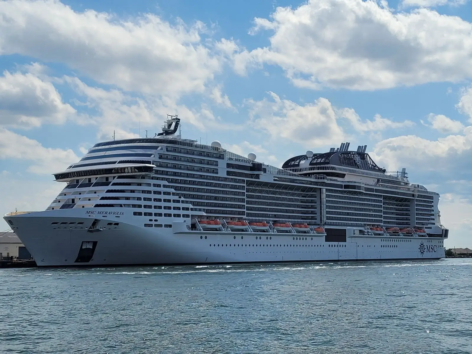MSC Meraviglia docked in Brooklyn in August 2023, with the ship's name on the bow