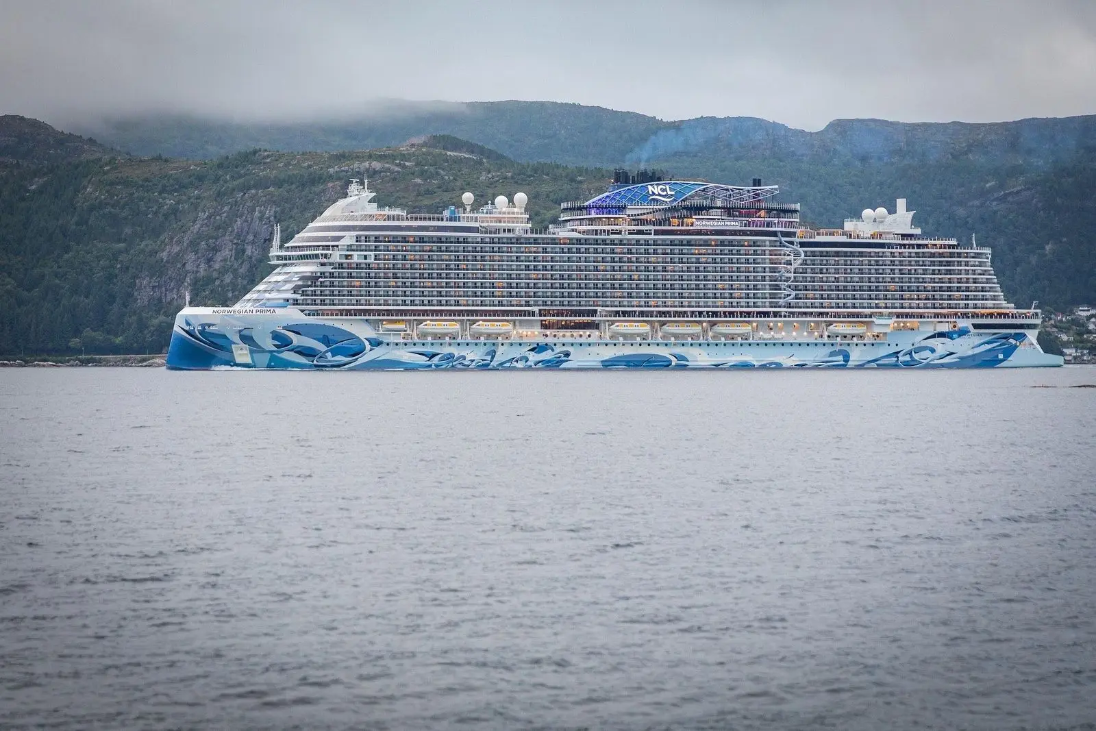 Norwegian Prima passing Husevåg in Nordfjord, Norway